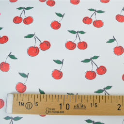 Tissu imperméable type ciré motif cerises fond blanc