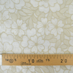 Tissu voile de coton brodé beige motif fleurs fond sable