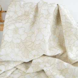 Tissu voile de coton brodé beige motif fleurs fond sable