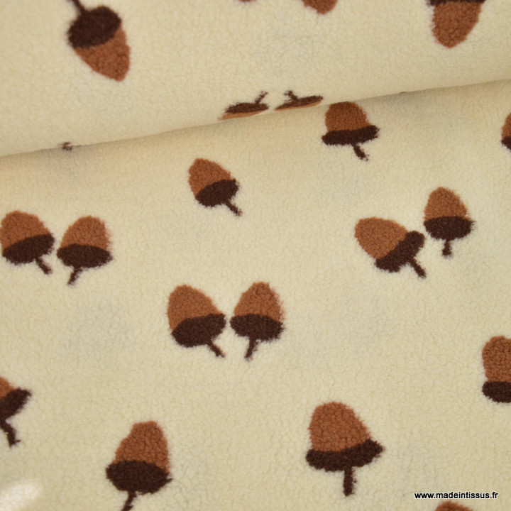 Tissu sherpa écru motif glands camel et chocolat