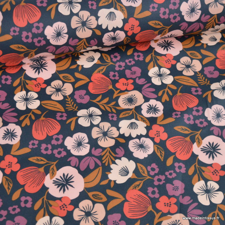 Tissu coton enduit Palawa motif fleurs skin fond bleu