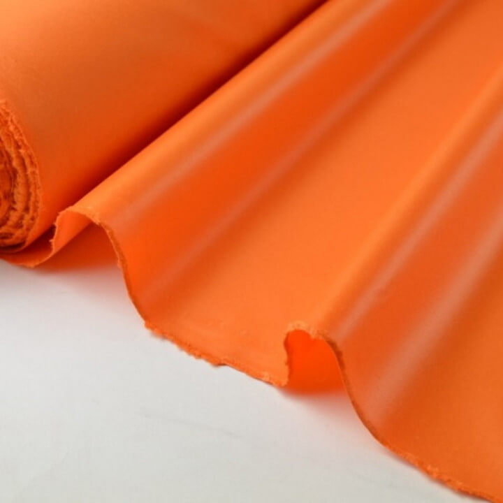 Tissu polyester orange déperlant pour parapluie .