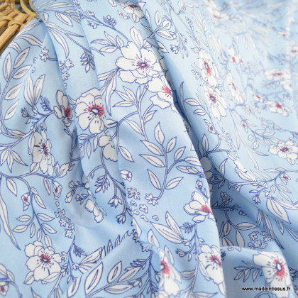 Tissu satin de Viscose motifs fleurs fond bleu ciel