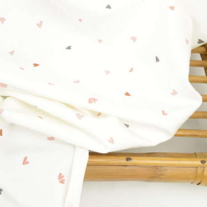 Tissu jersey Coreo motifs petits coeurs pêche fond blanc - oeko tex