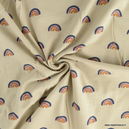 Tissu jersey motif arc en ciel fond beige - Oeko tex standard 100