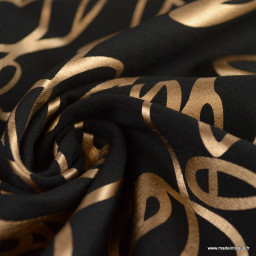Tissu Jersey milano lourd motif graphique doré fond noir