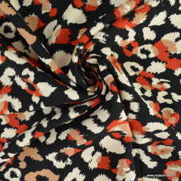 Tissu Viscose motif léopard orange et écru fond Noir