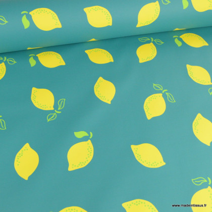 Tissu enduit ciré de pluie motif citrons fond vert emeraude