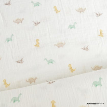 Tissu double gaze motif dinosaures fond blanc cassé