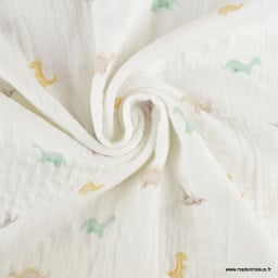 Tissu double gaze motif dinosaures fond blanc cassé