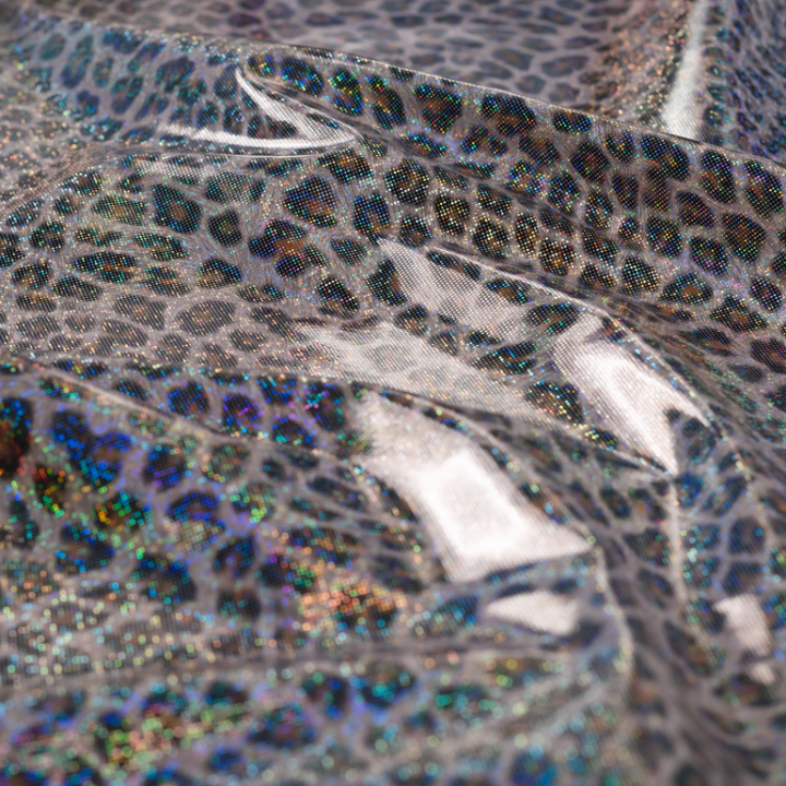 Tissu imperméable type ciré motif léopard à paillettes